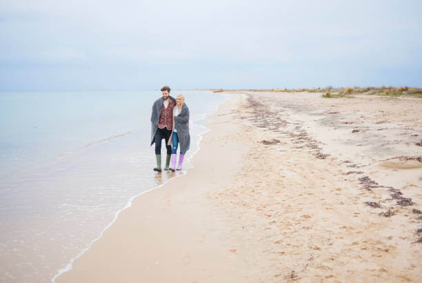 istock Couple walking at the beach 688441546