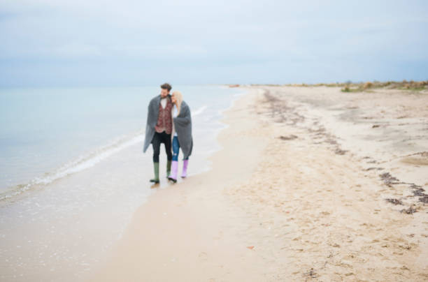 istock Couple walking at the beach 688441584