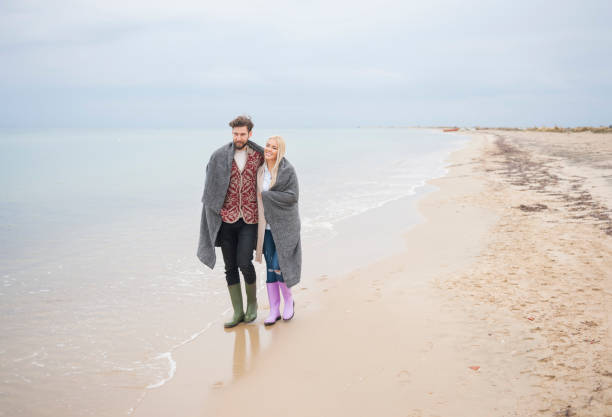 istock Couple walking at the beach 688441592