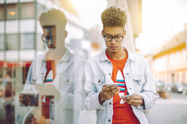istock Young man using phone in the city 688445090