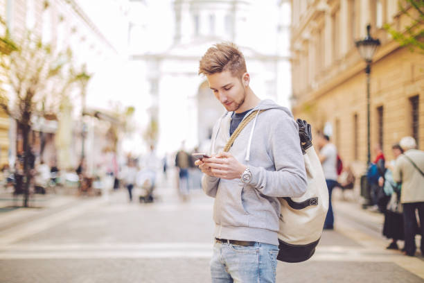 istock Young man using phone in the city 688445226
