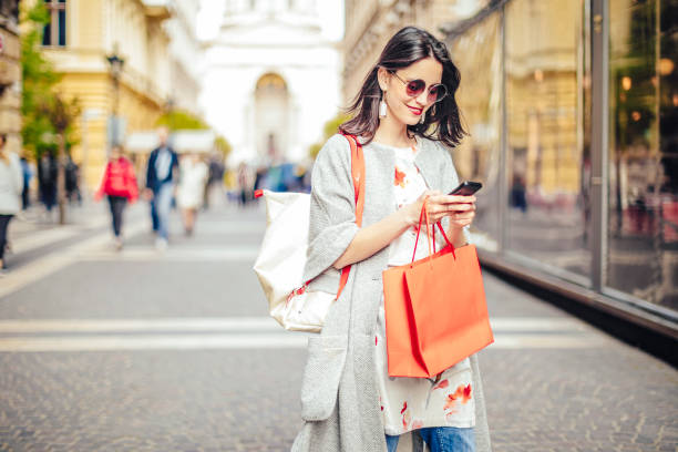 Beautiful woman spending time in the city Beautiful woman spending time in the city fashionable shopping stock pictures, royalty-free photos & images