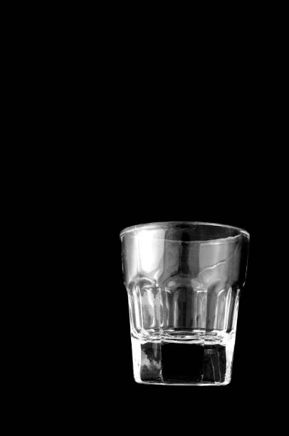 Empty shooter glass on black background stock photo