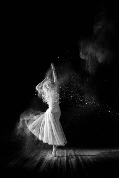 istock Beautiful ballet dancer, dancing with powder on stage 688451516