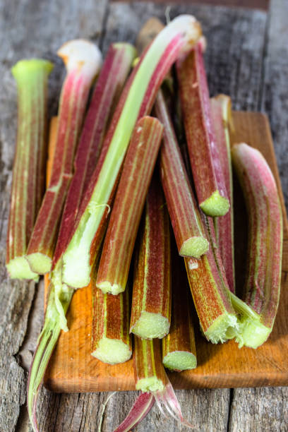 istock Fresh rhubarb stalks on wooden board for cutting 688454534