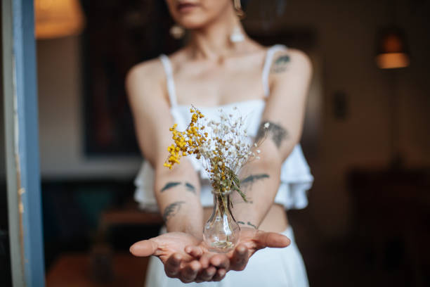 istock Hipster woman holding flowers 688454732