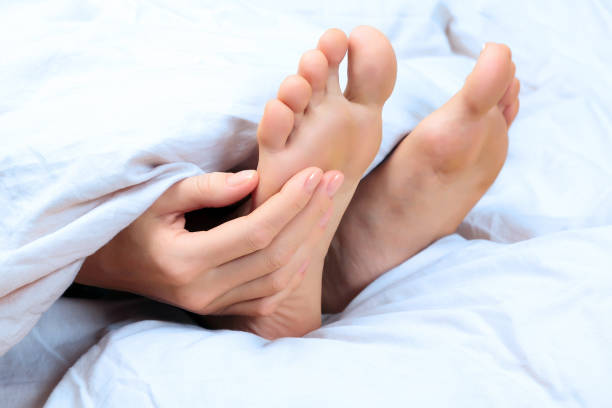 istock Woman scratches her foot 688454794