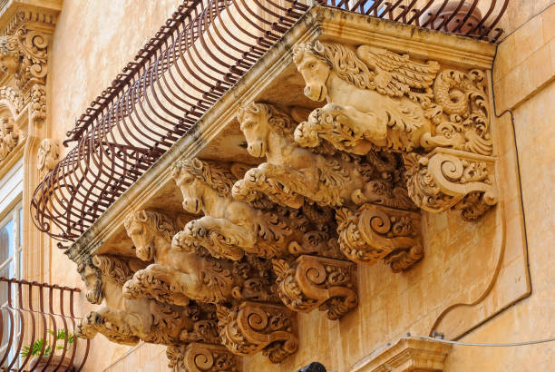 Winged Horses - Noto Wrought-iron balcony of the baroque Villadorata Palace in Via Nicolaci supported by five carved winged horses - Noto, Sicily, Italy noto sicily stock pictures, royalty-free photos & images