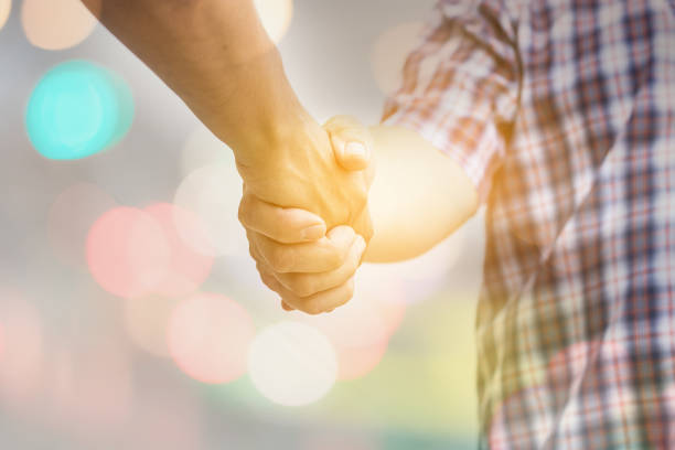 istock Two Asian people make handshake whit some success story in teamwork concept 688458346