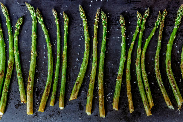 istock Baked asparagus on a dark background. 688458436