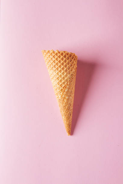 istock Simple ice cream cone. Pink background. Space for text. Top view 688465004