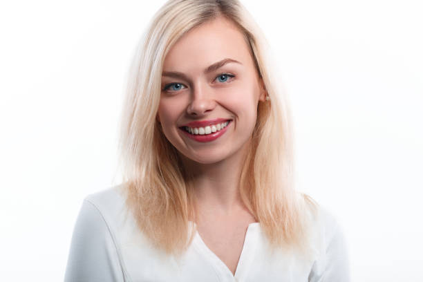 istock Beautiful woman smiling face close up studio on white. 688467948