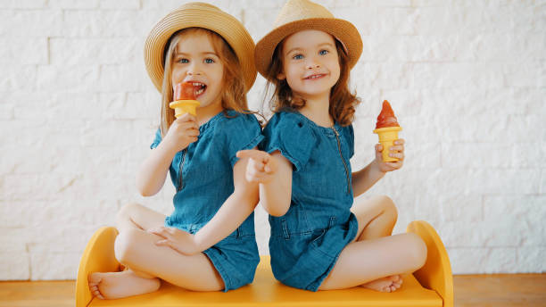 istock girls eat ice cream at home while waiting for vacation 688468638