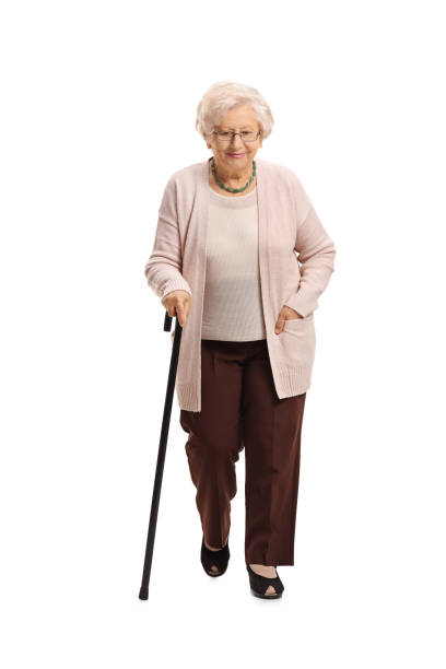 istock Mature woman with a cane walking 688471376