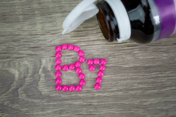 istock Pink pills forming shape to B7 alphabet on wood background 688472330