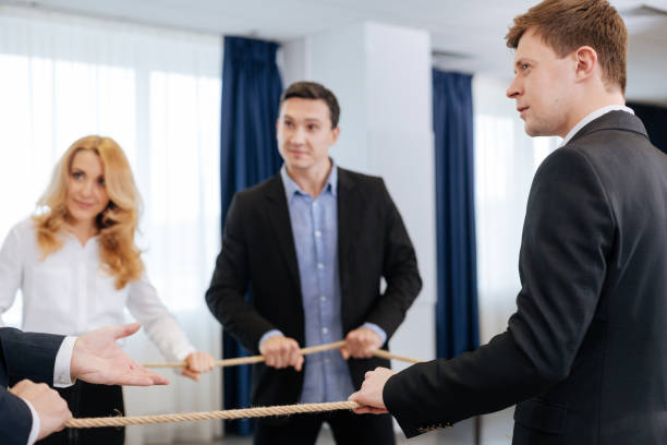 istock Nice pleasant man looking at the team leader 688474848