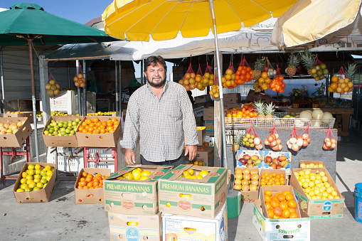 Hispanic Immigrant Proudly Stands by His Fruits and Vegetables He Has for Sale at the Immokalee Farmer's Market During the Week