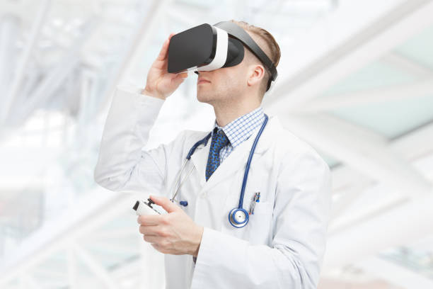 Indoors close up shot of male doctor wearing VR glasses stock photo