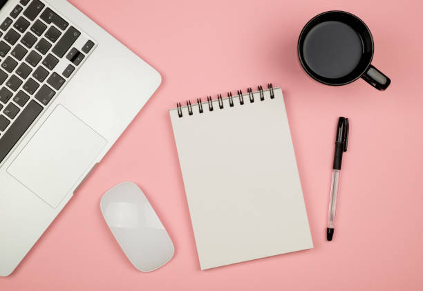 istock Modern office desk table with laptop, blank notebook page for input the text in the middle and other supplies. Top view, flat lay 688476390