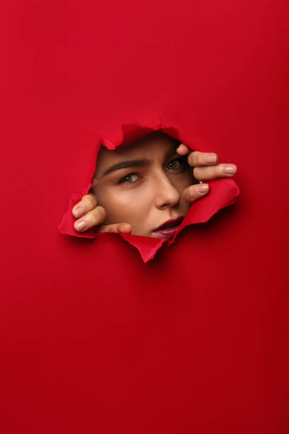 istock Woman posing in hole in paper 688480300