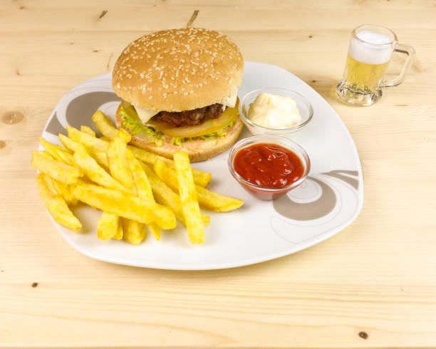 istock Burger and chips on wooden background 688485620