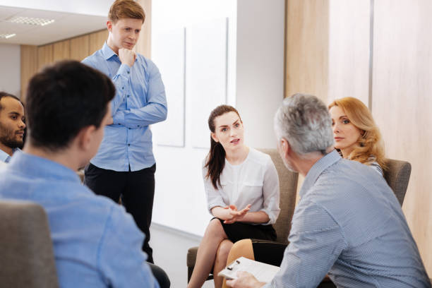 istock Handsome thoughtful man listening to the group discussion 688488672
