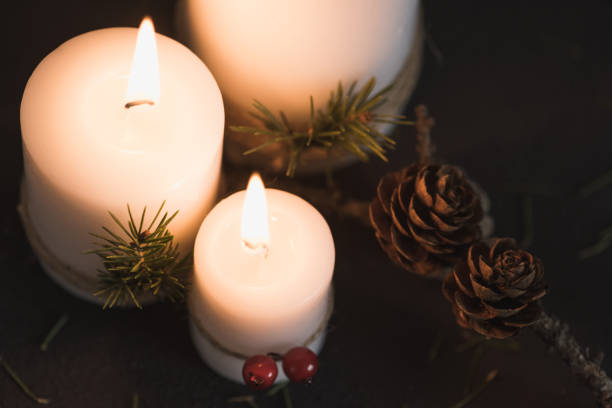 istock Christmas decorations on tha table with lit candles 688491216