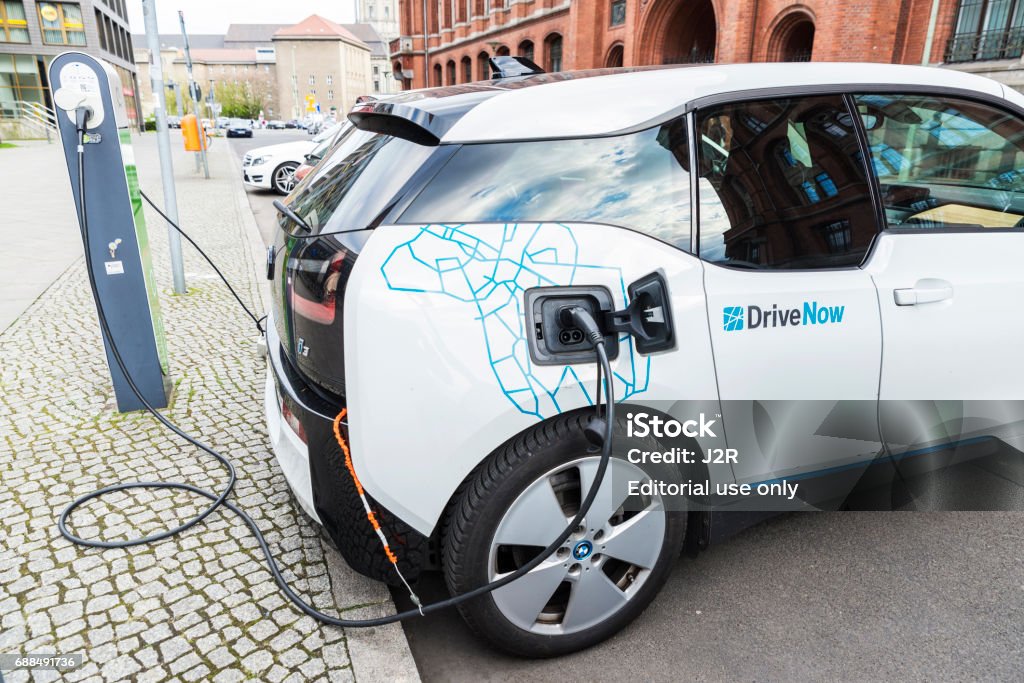 Electric car recharging the batteries in Berlin, Germany Berlin: Electric car, model BMW i3, of a company of carsharing called Drivenow recharging the batteries in Berlin, Germany Carsharing Stock Photo