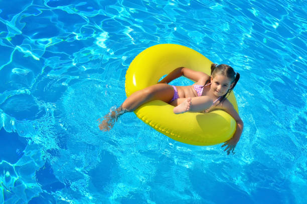 istock Adorable toddler relaxing in swimming pool 688494610