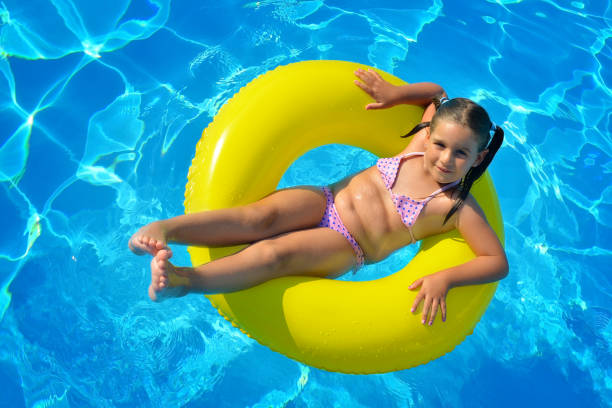 istock Adorable toddler relaxing in swimming pool 688494806