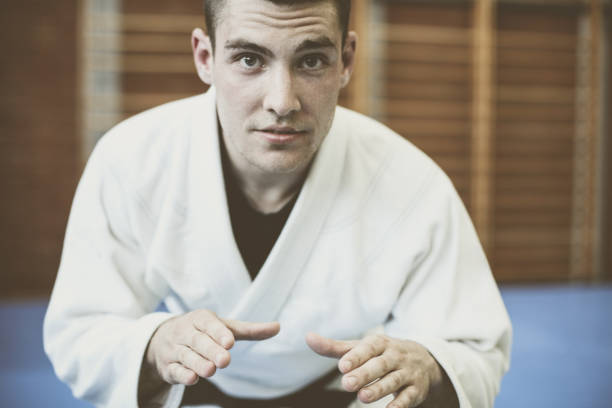 istock Young male practicing judo in kimono. Looking at camera. 688495186