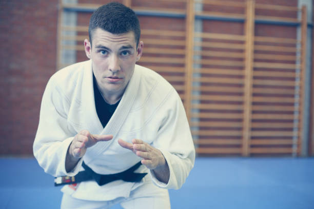 istock Young male practicing judo in kimono. Looking at camera. 688495258