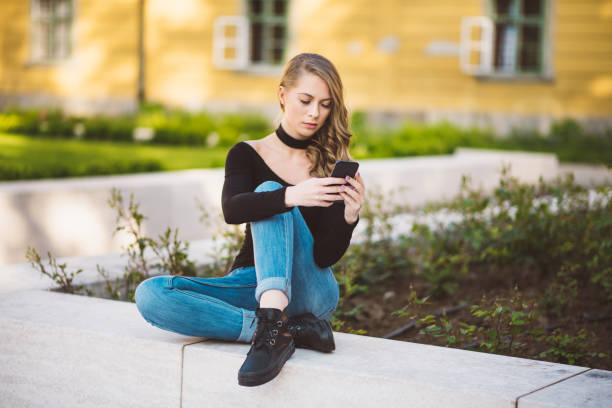 istock women using smart phone in city 688498280