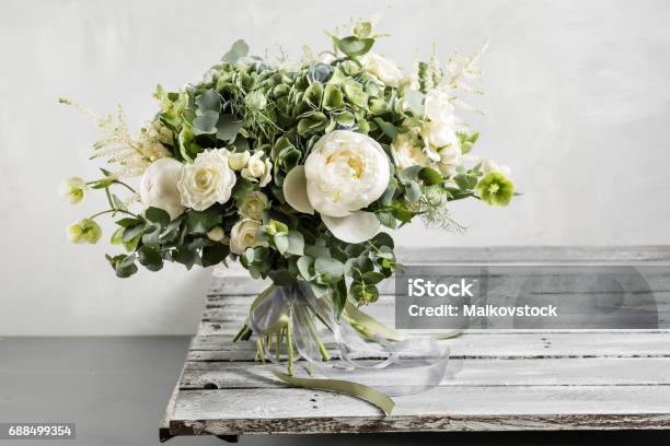 Bridal Vintage Bouquet The Brides Beautiful Of Mixed Flowers And Greenery Decorated With Silk Ribbon Lies On Vintage Wooden Table Vintage Style Stock Photo - Download Image Now