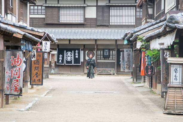 istock Samurai walks down street in tradtional old style Japanese town 688500024