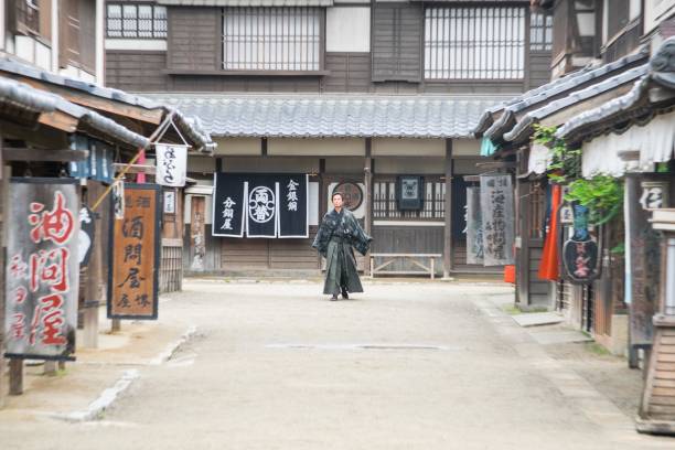 istock Samurai walks down street in tradtional old style Japanese town 688502548