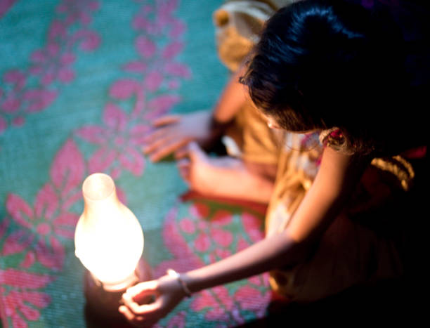 istock Girl sitting on carpet with lamp 688502770