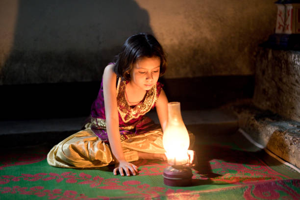 istock Girl sitting on carpet with lamp 688502852
