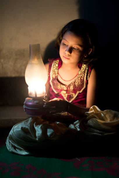 istock Girl holding oil lamp 688502944