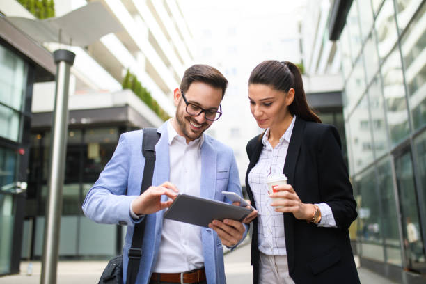 istock Coworkers brainstorming over new project using digital tablet outdoors 688502974