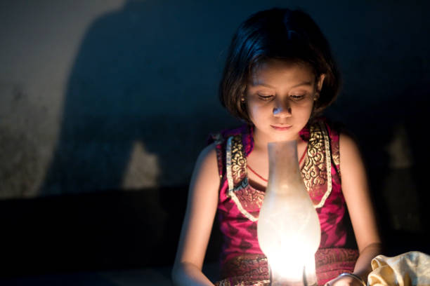 istock Girl holding oil lamp 688503030