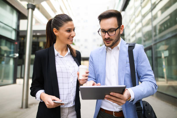 istock Coworkers brainstorming over new project using digital tablet outdoors 688506026