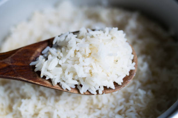 istock Cooked rice in pot with wood ladle 688506088