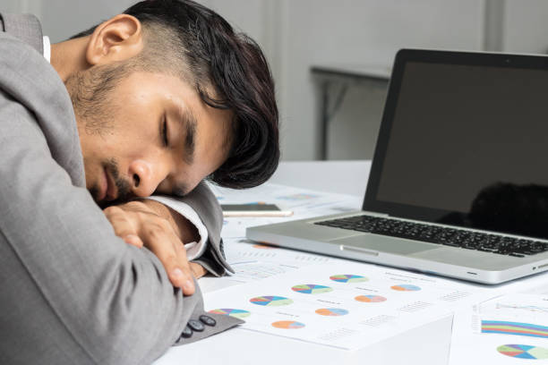 istock Tired businessman sleeping on work desk 688519596