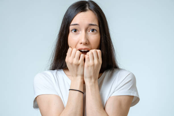 istock Beautiful young woman with a fear expression isolated over white background 688525926