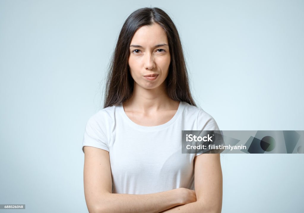 Young serious angry woman portrait isolated on white background Anger Stock Photo
