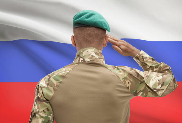 istock Dark-skinned soldier with flag on background - Russia 688526784