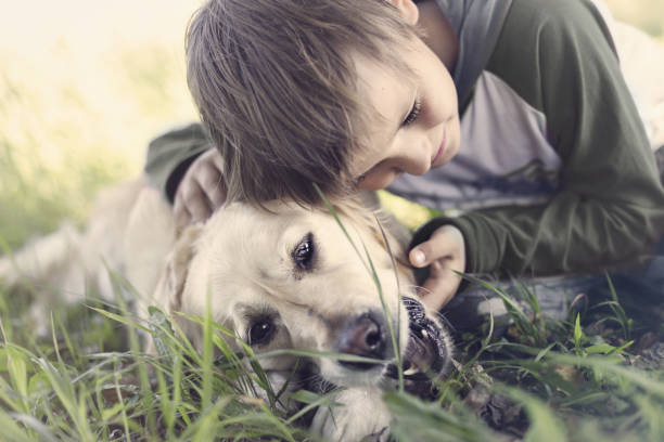 istock Small boy embracing sweetly his dog 688531724