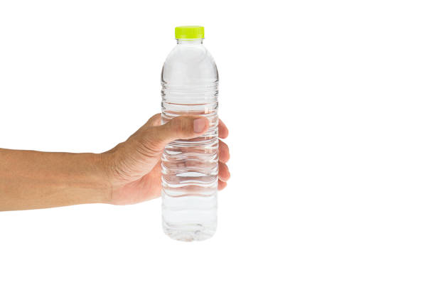 istock Man's hand holding drinking water bottle isolated on white background 688536774