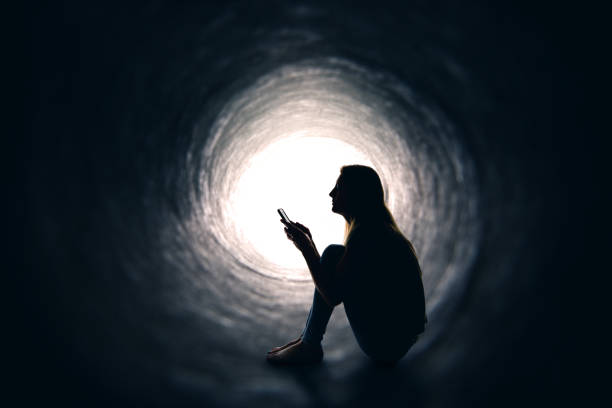 Woman In Tunnel WIth Phone stock photo